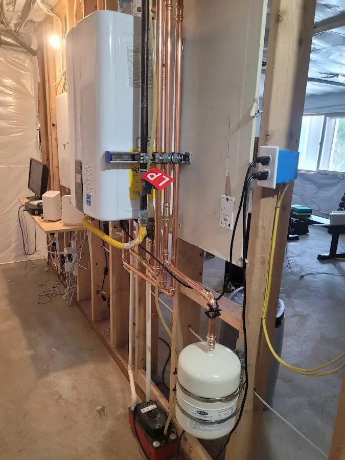 Licensed plumber repairing a kitchen sink in Maynard
